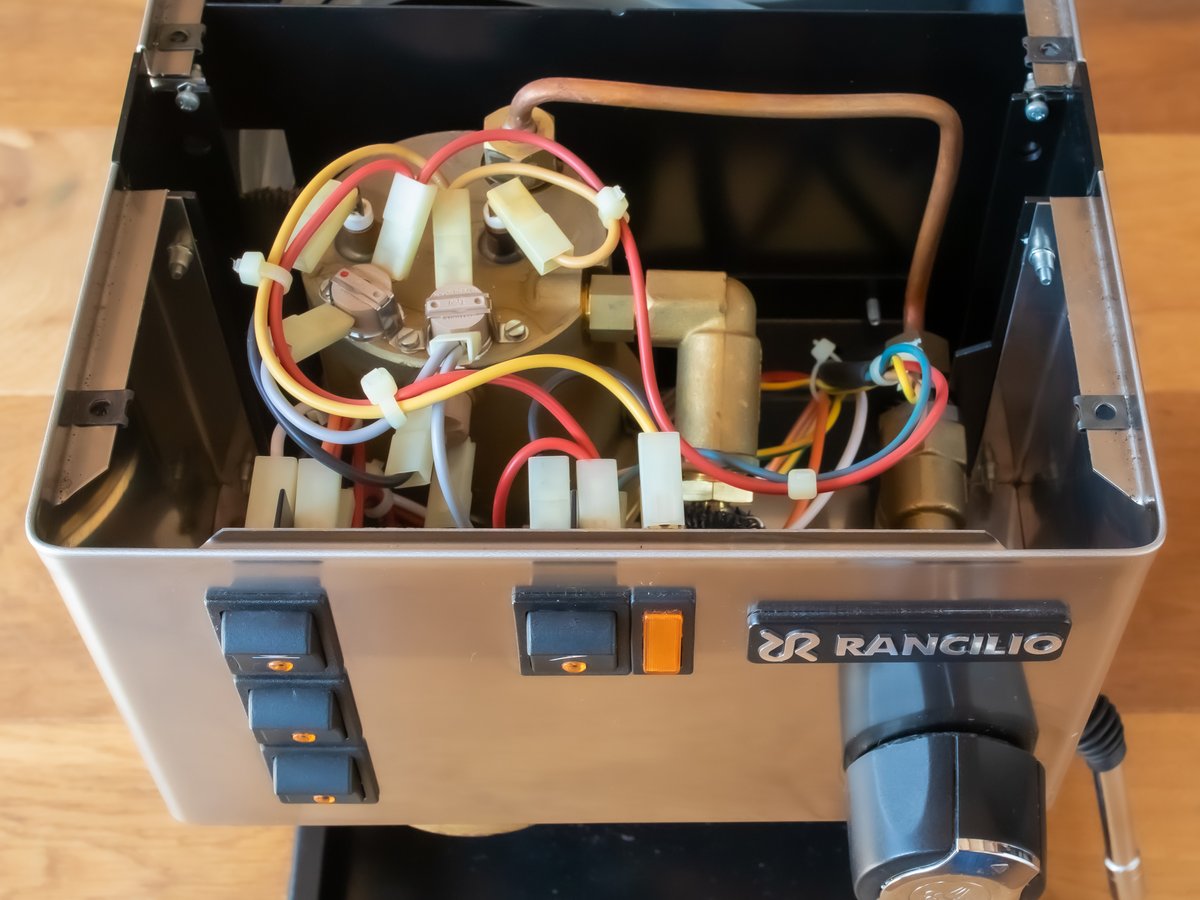 A clean espresso machine group head after a flush
