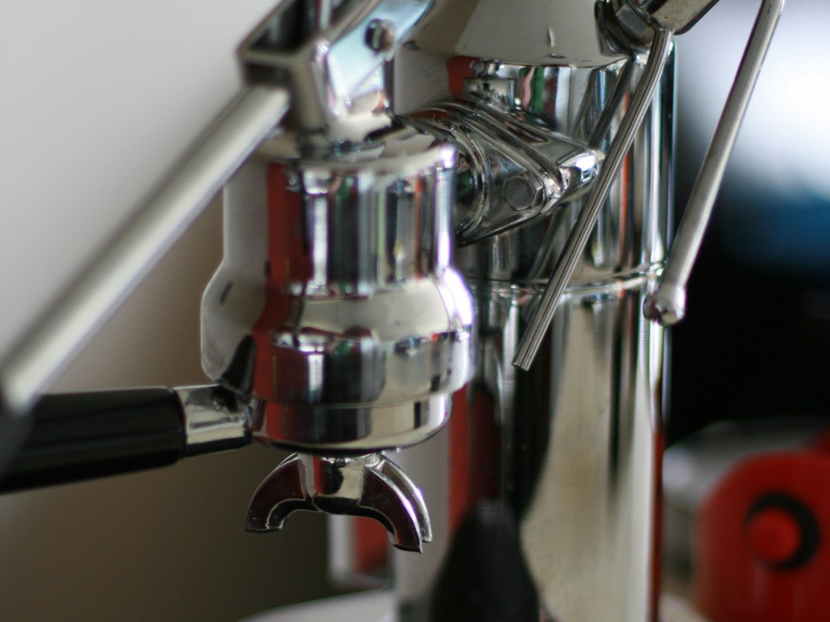 Several home espresso machines on a counter