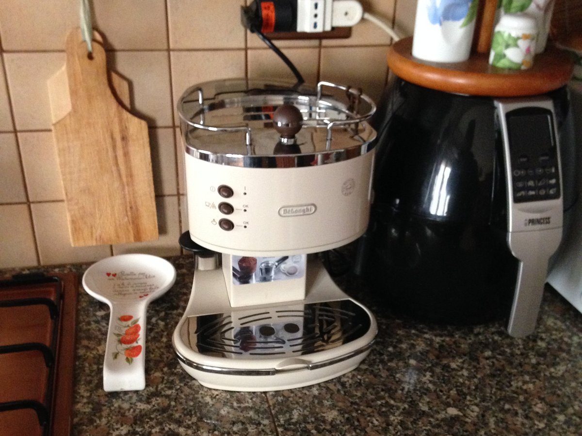 A home espresso machine and grinder on a kitchen counter