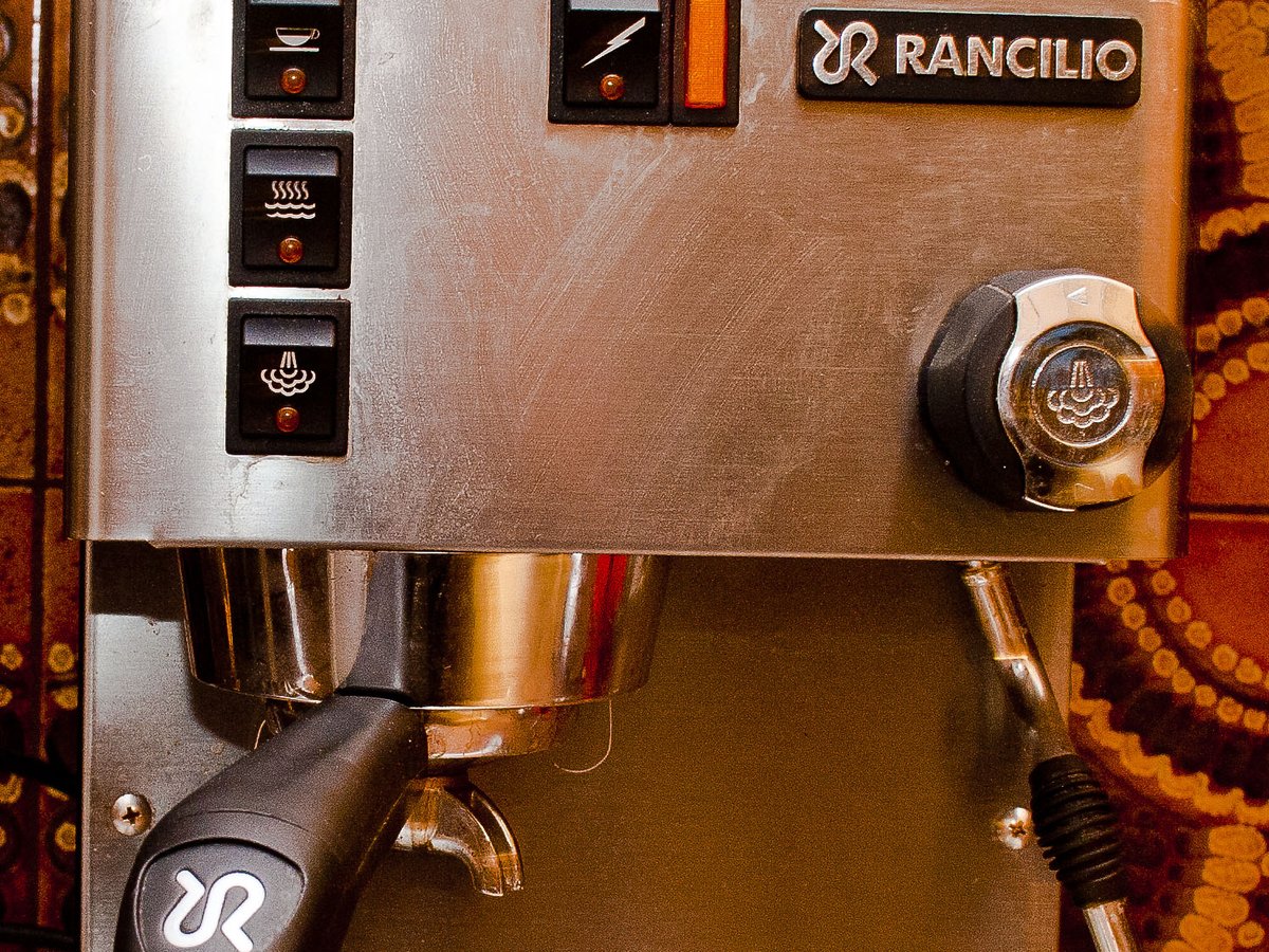 An espresso machine pulling a shot into two cups